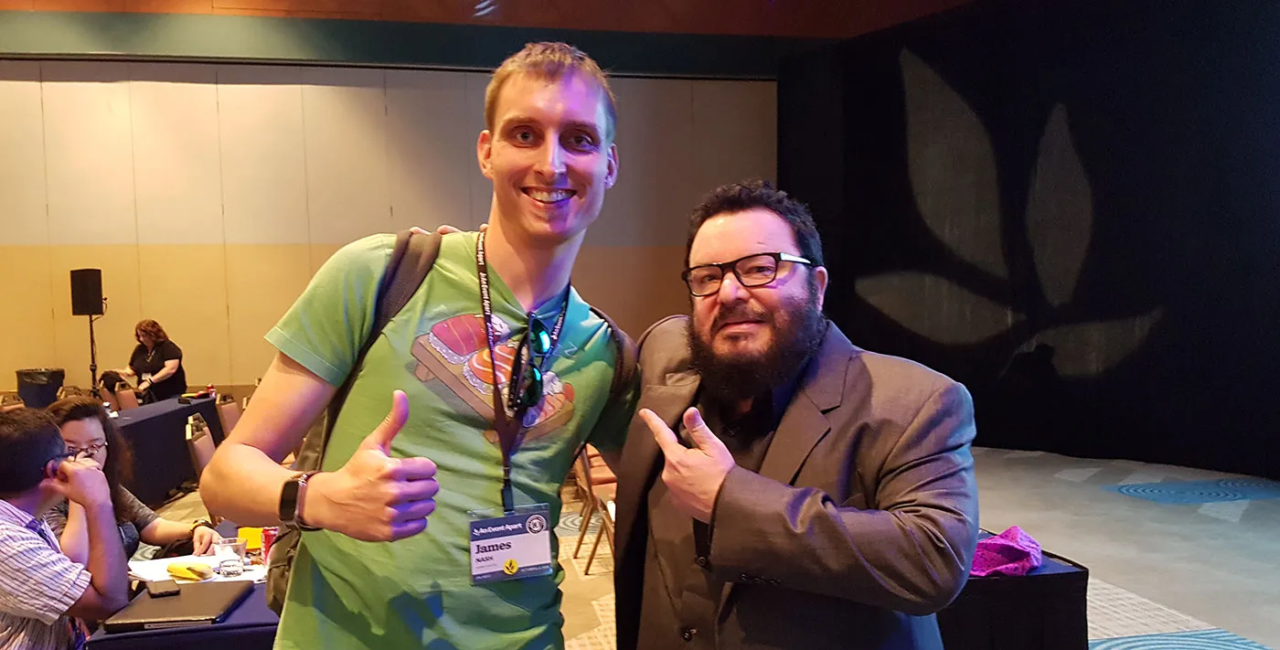 Me posing with web design legend Jeffrey Zeldman. I've got a big, stupid grin on my face and am making a thumbs up gesture. He's pointing at me. I'm also a head taller than him.