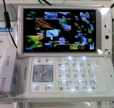 A white, dual-hinge clamshell phone sporting a high resolution display