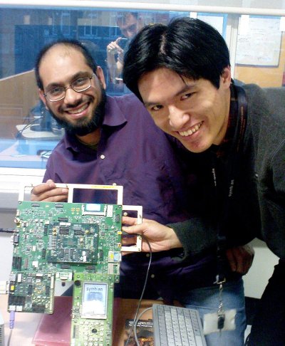 Rehan and Simon, developers at Symbian, pose next to a development board running the demo