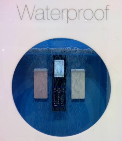 A switched-on, waterproof phone that is fully submerged in a water tank